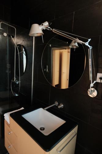 a bathroom with a sink and a mirror at PÉ AZUL - Turismo em Espaço Rural - Parque Natural de Montesinho in Bragança