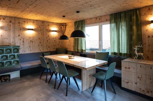 a dining room with a wooden table and chairs at Luxury Eco-Chalet Pino Achensee ski-in ski-out for 6 or more in Achenkirch