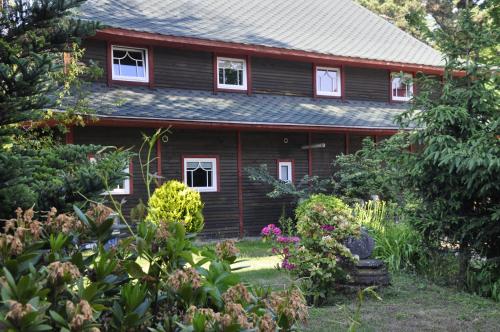 a house with a garden in front of it at Hotel Garden in Bolesławiec