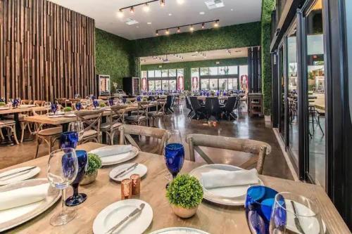 a dining room with tables and chairs in a restaurant at 4 BR Home w/ Resort Amenities + 3 Mi to Disney in Orlando
