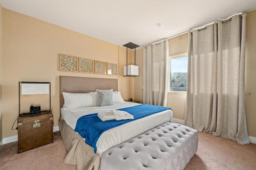 a bedroom with a large bed and a window at Outdoor Kitchen + 8 Min to Disney + Resort Cabanas in Orlando