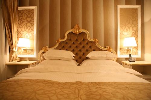a bedroom with a large bed with two pillows at Hotel Villa Viktorija in Banja Luka