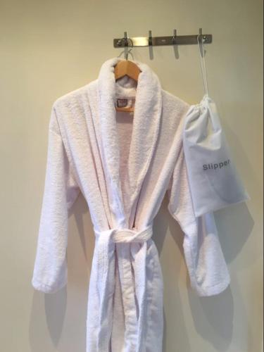 a white robe is hanging on a hanger at Brooklands in Tavistock