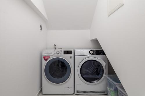 a laundry room with a washer and dryer at House7E in Šmrika