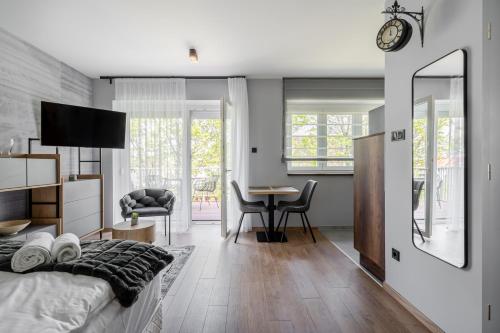 a bedroom with a bed and a table with a chair at Radnoti Home in Veszprém