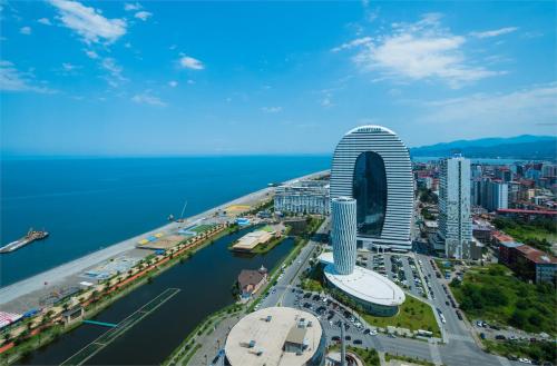 an aerial view of a city with a tall building at Panorama Sea Side Central Batumi in Batumi