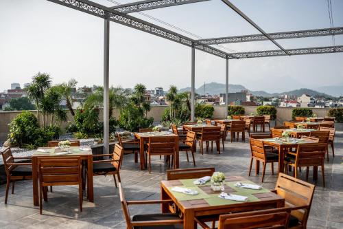 a restaurant with tables and chairs on a patio at Crowne Plaza Vinh Yen City Centre by IHG in Yen
