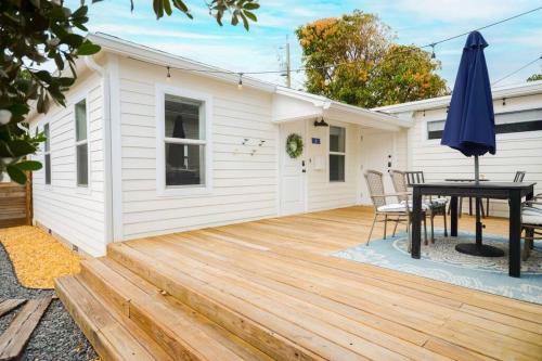 a patio with a table and an umbrella at Sabal Palm Vacation Homes in Lake Worth