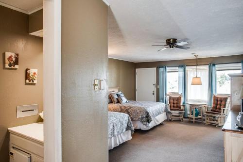 a bedroom with a bed and two chairs in it at Cliff Dwellers Inn in Blowing Rock