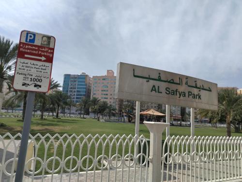 a sign for a park next to a fence at شقق مفروشة Apartment 2 Bedroom Majaz3 in Sharjah