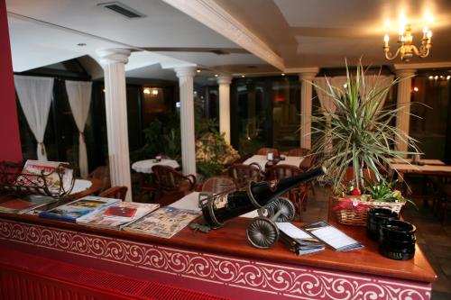 a table with a wine bottle on top of it at Hotel Villa Viktorija in Banja Luka