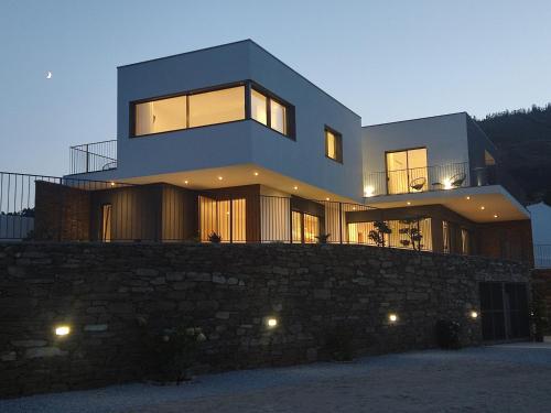 a large house on top of a stone wall at Douro - Quinta das Manas - Baião in Alcarias