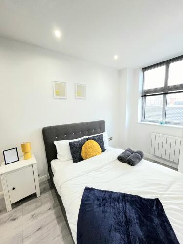 two beds in a bedroom with white walls at Leicester City Centre Flat in Leicester