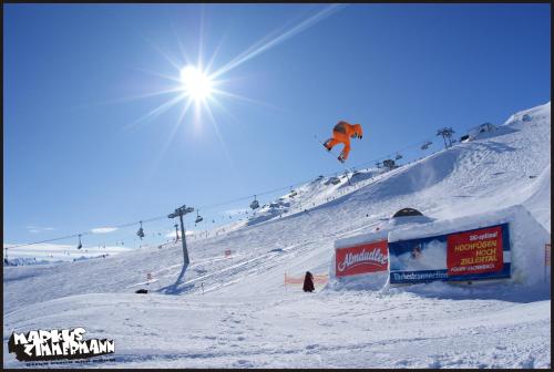 a person is flying in the air on a snow covered slope at Ferienwohnung Bergheim in Fügenberg