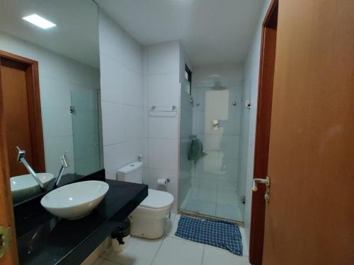 a bathroom with a sink and a shower and a toilet at Flat no loa Resort & Residence in Barra de São Miguel