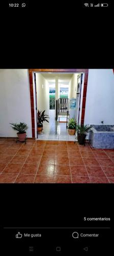 a picture of a hallway with plants in a house at Hotel Bellota in Parras de la Fuente