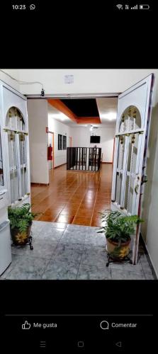 a room with two doors and two potted plants at Hotel Bellota in Parras de la Fuente