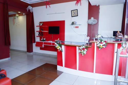 a red kitchen with a counter with a tv at Hotel elibrista in Meerut