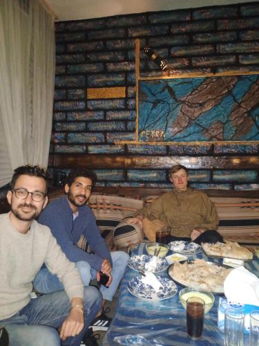 a group of men sitting around a table at Petra Musa Rural House in Wadi Musa