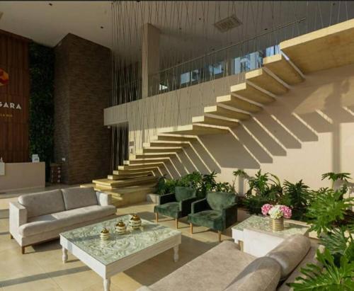 a living room with a staircase with couches and tables at Hermoso apartamento, moderno, club house, excelente ubicación!, in Neiva