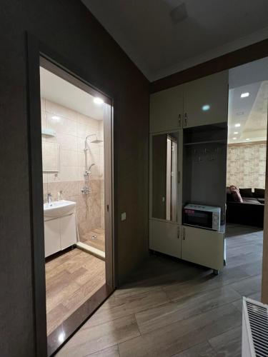 a bathroom with a shower and a sink and a tub at vekuas apartments in Tbilisi City