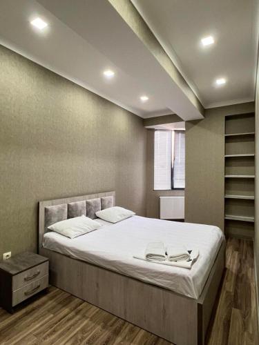 a bedroom with a large bed in a room at vekuas apartments in Tbilisi City