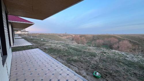 a porch of a house with a view of a field at Домик у реки 