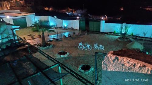a bike is parked in a courtyard at night at CASA CUEVA EL OLIVO in Pegalajar