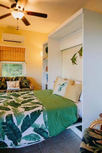 a bedroom with a bed and a ceiling fan at Fiesta in Enighed