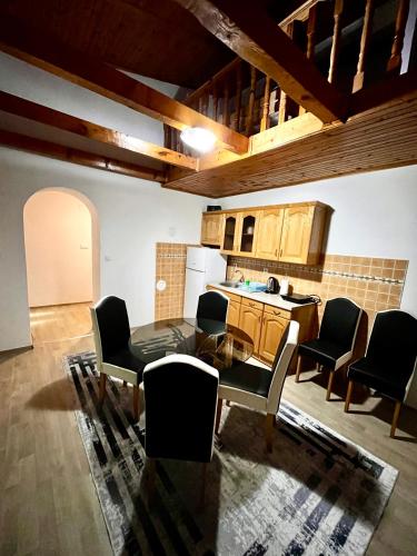 a kitchen with a table and chairs in a room at Apart Cobras Jajce in Jajce