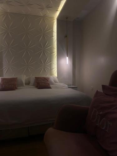 a bedroom with a bed and a couch in it at شالية ديور الفندقي in Al Wudayy