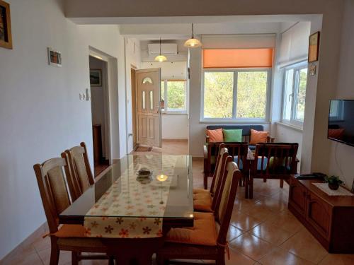 a dining room and living room with a table and chairs at Apartments by the sea Sali, Dugi otok - 8117 in Sali