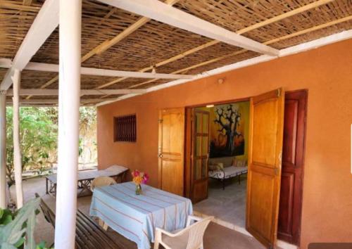 a room with a table and chairs and a room with at Villa keur Fatou in Sali Nianiaral