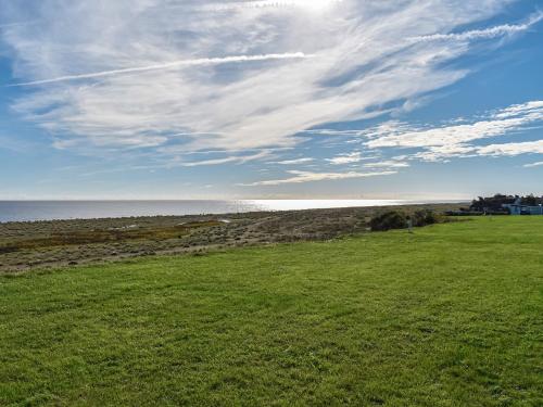 a green field with the ocean in the background at Seascape in Kessingland