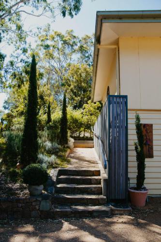 a house with a blue gate and stairs at Glan-y-mor Studio in Metung in Metung