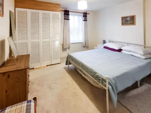 a bedroom with a large bed and a window at Colin Grove Retreat in Brigham