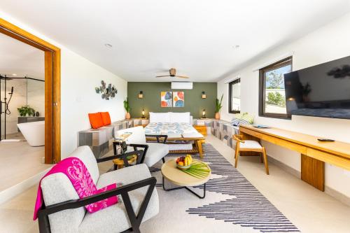 a living room with a couch and a table at Jade I Long Bay Retreat I Luxury Stay Near Grace Bay & Long Bay Beach in Long Bay Hills