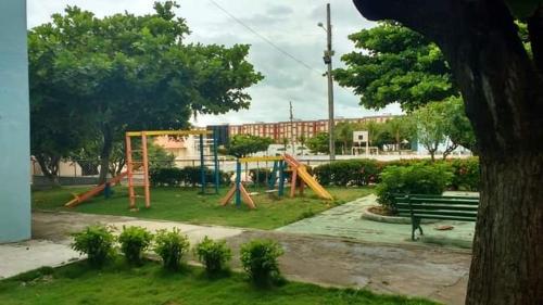 a park with a playground with a swing set at Apartamento Aluguel Morro Branco. in Beberibe