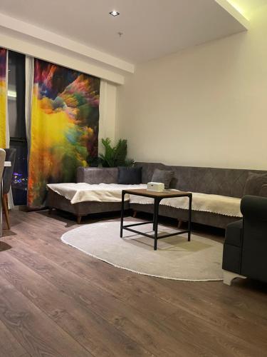 ein Wohnzimmer mit einem Sofa und einem Tisch in der Unterkunft Brand & Luxurious Suite near- Mall of Istanbul in Istanbul
