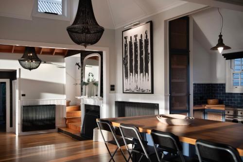 a dining room with a wooden table and chairs at Queensberry Hill View- luxury group retreat in Daylesford