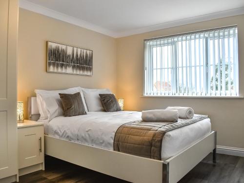 a bedroom with a bed and a window at Buckthorn House in Middlesbrough