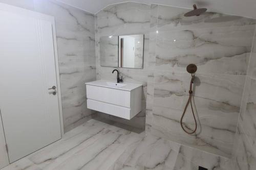 a white bathroom with a sink and a mirror at Luxurious Villa at the country side! in Tel Aviv