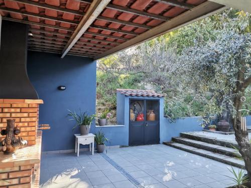 a blue house with a blue door and stairs at Quinta Souto da Ordem - House in Castelo Novo