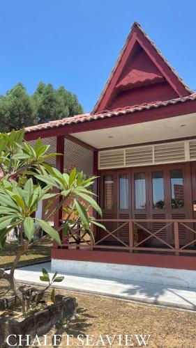 a small house with a red roof at Lovita Tanjung Bidara Beach Resort in Melaka