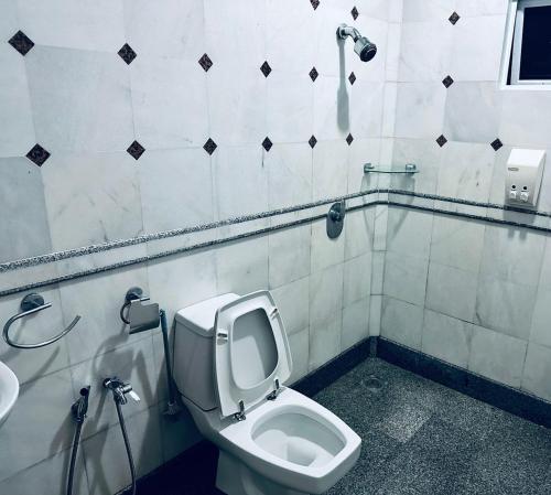 a bathroom with a toilet and a sink at Green Villa Grandeur at A Famosa Resort Melaka in Kampong Alor Gajah