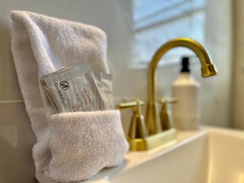 a white towel sitting on a bathroom sink at Spring Street Suites in Evansville