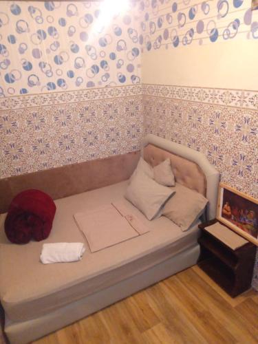 a bed in a room with a wall at riad kamal in Rabat