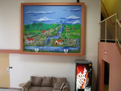 a painting on the wall of a living room with a couch at Vista Motel in Los Angeles