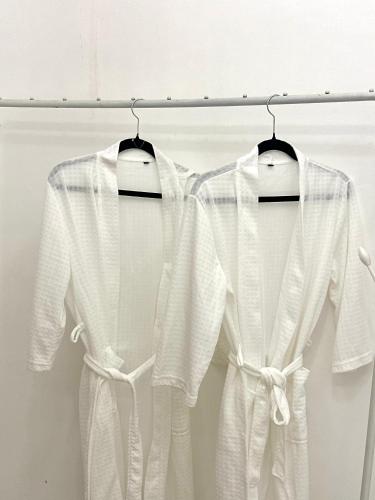 a couple of white shirts hanging on a rack at Sunshine Cabin in General Santos