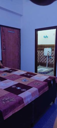 a bedroom with a bed with a mirror and a sink at OYO Hotel Royal Palace in Bulandshahr